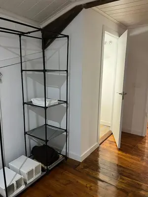 a black book shelf in a room with a hallway at Acogedor apartamento del Casco Antiguo de Ourense in Ourense