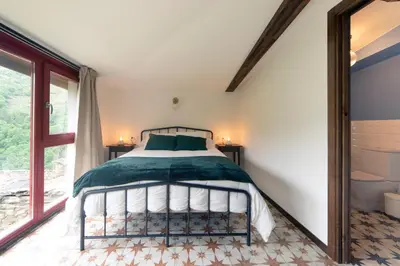 a bedroom with a bed and a window at Casa do Mao in San Lorenzo de Barjacoba