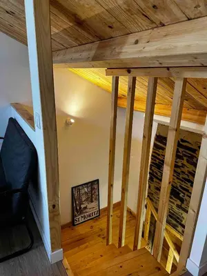 a room with a wooden ceiling with wooden floors at A Casiña da Ponte in Lugo