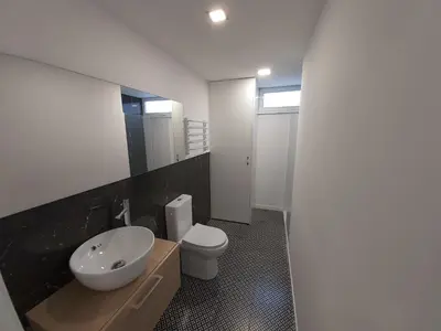 a bathroom with a white sink and a toilet at Casa en el Valle in Santa Eulalia