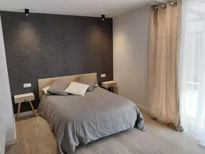 a bedroom with a bed and a large window at Casa en el Valle in Santa Eulalia