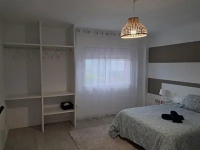 a bedroom with a bed and a window and a lamp at Casa en el Valle in Santa Eulalia
