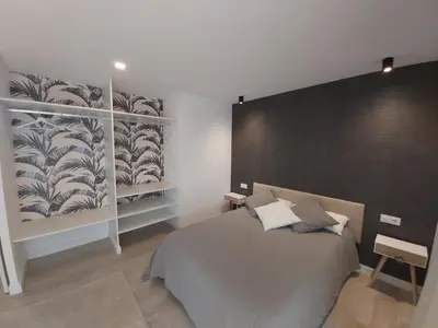 a bedroom with a large bed and a large wall at Casa en el Valle in Santa Eulalia