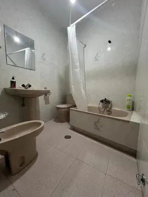 a bedroom with two beds with green comforters and a window at La Morada del Peregrino Miño Center Home in Miño
