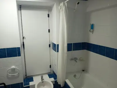 a bathroom with a shower and a sink and a toilet at Habitaciones Rurales Los Semellones in La Llama