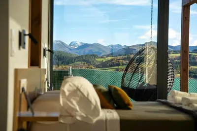 a bedroom with a hammock and a view of mountains at Cabanas do Chao