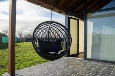 a black hammock swing hanging from a roof at Cabanas do Chao
