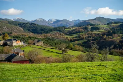 a green pasture with mountains in the background at Cabanas do Chao
