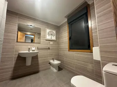 a bathroom with a sink and a toilet at Pensión Villa Mayer - Grupo Arcanos in Caldas de Reis