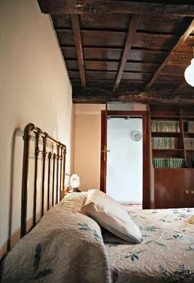 a bedroom with a bed and a wooden ceiling at Casa do Botas in Sober
