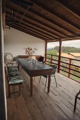 a wooden table and chairs on a wooden deck at Casa do Botas in Sober
