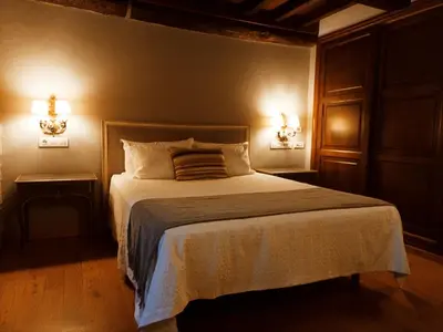 a bedroom with a large bed with two night stands at Vila As Pedras in Roxos