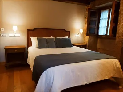 two beds in a hotel room with towels on them at Vila As Pedras in Roxos