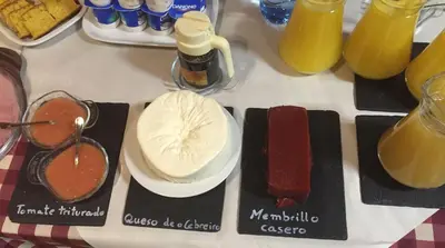 a table topped with different types of food and drinks at Complexo Xacobeo in Tríacastela