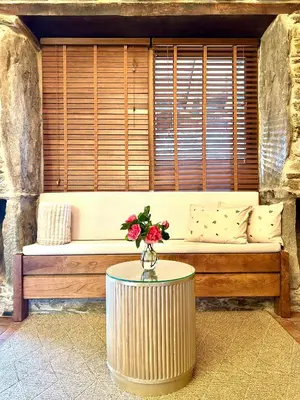 a couch with a table with a flower on it at A Maquía de Medín in O Pino