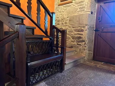 a set of stairs with a wooden door in aoyer at Casal Rural Val Fresco - Casa Hórreo in Curantes