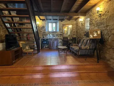 a living room with a couch and a table at Casa Rural Val Fresco - Casa Piano in Curantes
