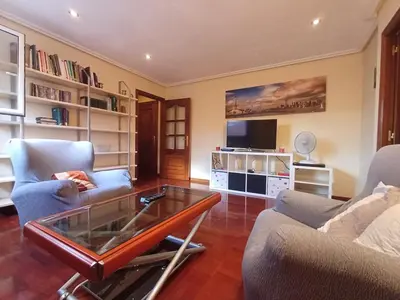 a living room with two couches and a glass coffee table at Mirador Residencia in Ourense