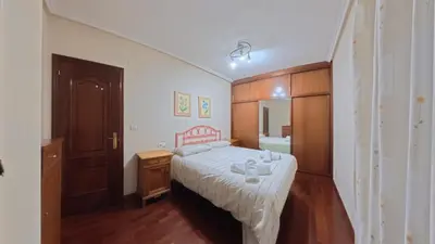 a bedroom with a bed and a wooden cabinet at Mirador Residencia in Ourense