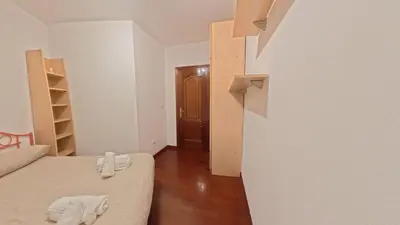 a small room with two beds and a hallway at Mirador Residencia in Ourense