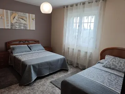 a bedroom with two beds and a window at Casa Castro in A Estrada