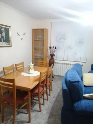 a dining room with a table and a blue couch at Casa Castro in A Estrada