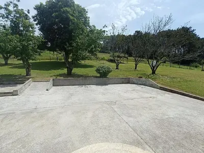 a skateboard ramp in a park with trees in the background at Casa Castro in A Estrada
