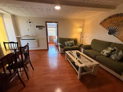a living room with a couch and a table at A Casiña de Coles in Gustey
