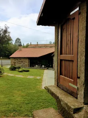 an entrance to a building with a wooden door at Casa Garea in Arzúa