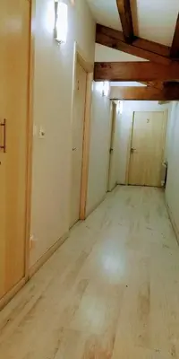 an empty room with wood floors and a ceiling at Casa Garea in Arzúa
