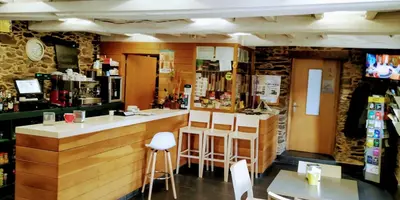 a bar in a restaurant with a counter and chairs at Casa Garea in Arzúa