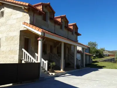 a building with a porch and stairs on it at Casa Requias in Requiás