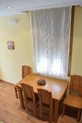 a wooden dining room table with chairs and a window at Casa Requias in Requiás