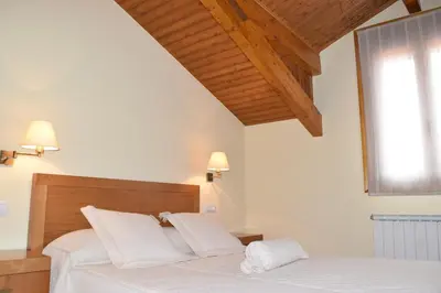 a bedroom with a bed with white sheets and a window at Casa Requias in Requiás
