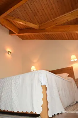 a bedroom with a bed with a wooden ceiling at Casa Requias in Requiás