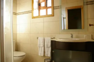 a bathroom with a sink and a toilet and a mirror at Casa Requias in Requiás