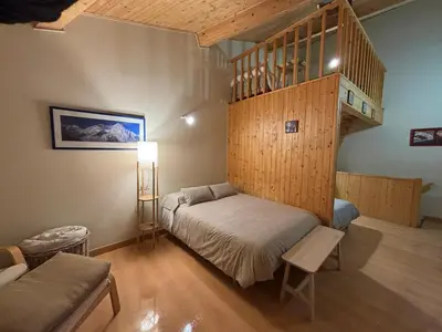 a bedroom with a bunk bed and a staircase at O lar do Arroio in Allariz