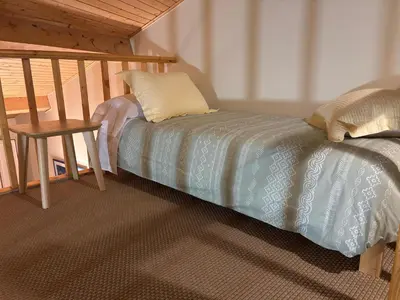 a bed with a pillow and a table in a room at O lar do Arroio in Allariz