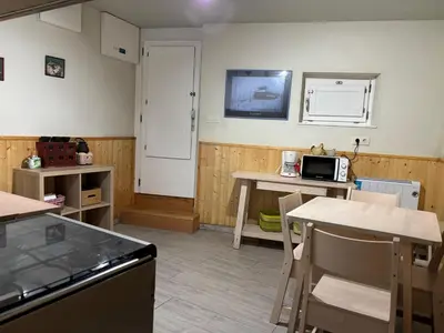 a kitchen with a table and chairs and a counter top at O lar do Arroio in Allariz