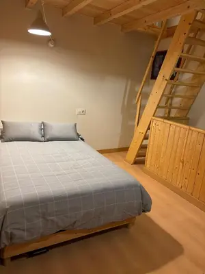 a bedroom with a bed and a staircase at O lar do Arroio in Allariz