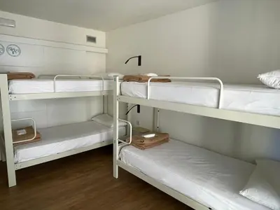 a room with white cabinets and a hard wood floor at Albergue Guiana in Ponferrada
