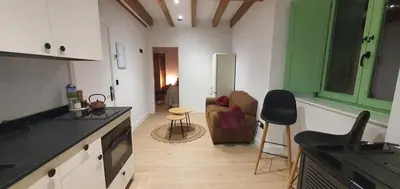 a kitchen and living room with a couch and a table at El Sueño in Barres