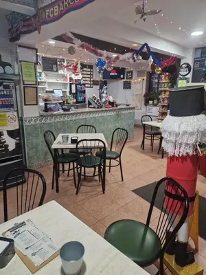 a restaurant with tables and chairs and a counter at Fogar do Gabino in Padrón