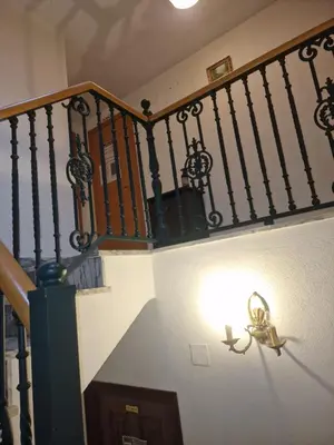 a stair railing with a light at the bottom of a staircase at Fogar do Gabino in Padrón