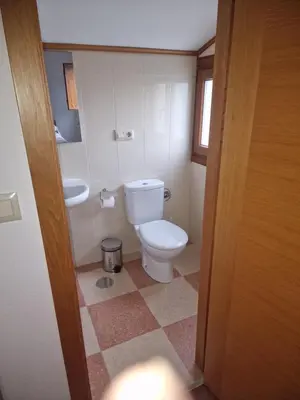 a bathroom with a toilet and a sink at Fogar do Gabino in Padrón
