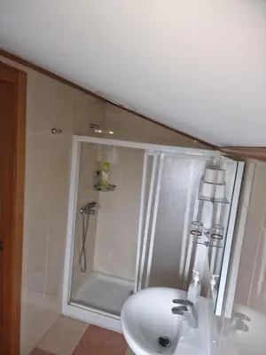 a bathroom with a shower and a sink at Fogar do Gabino in Padrón