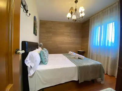 a bedroom with a bed with two stuffed animals on it at Casa Rosiña in Campo Lameiro