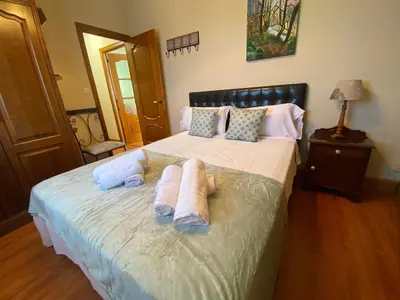 a bedroom with a bed with towels on it at Casa Rosiña in Campo Lameiro
