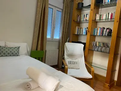 a bedroom with a bed and a book shelf at Casa Rosiña in Campo Lameiro