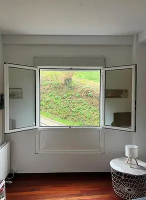 a large window in a room with a table at Tineo centro in Tineo